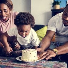 child blowing out birthday candles