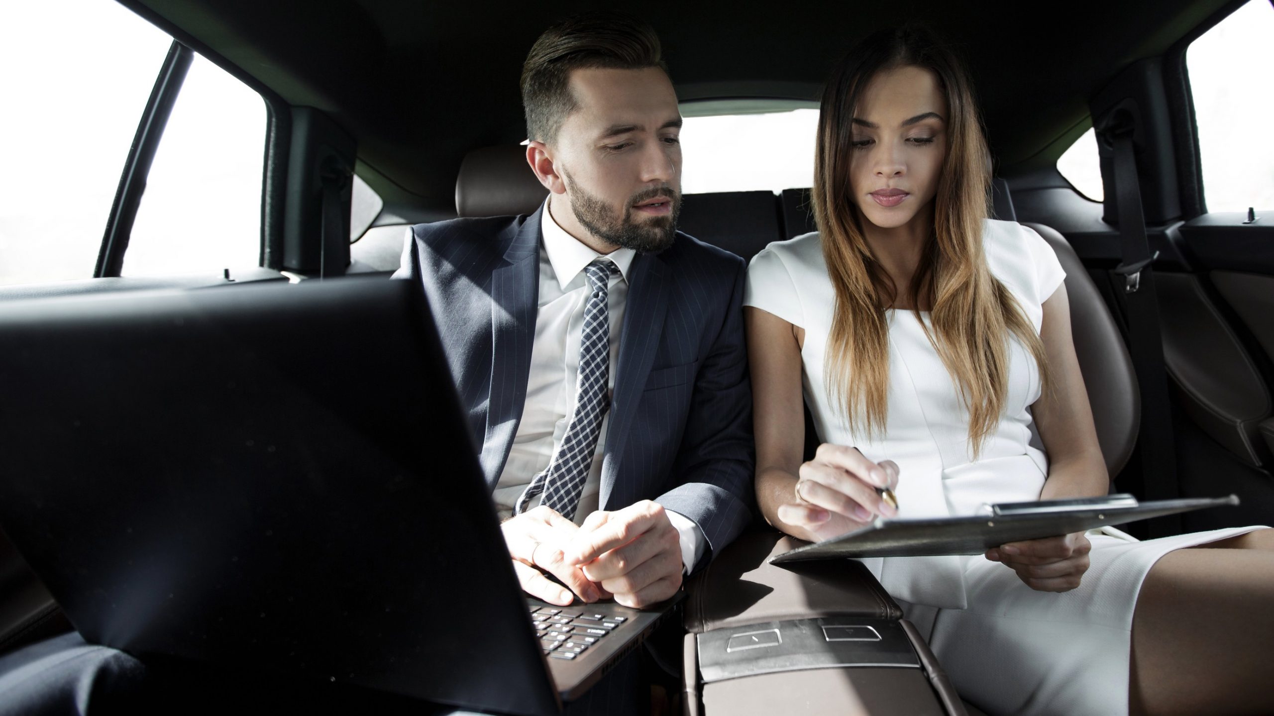 business man and woman in limo