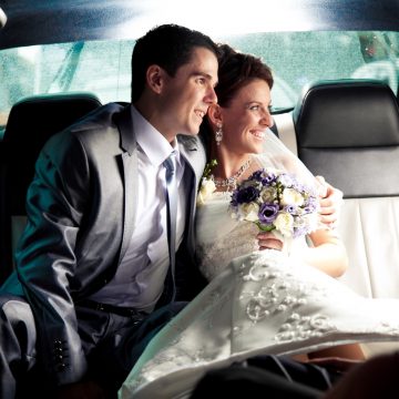 bride and groom in limo to airport